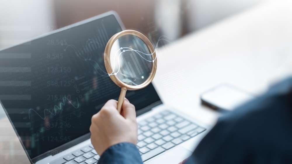 Looking at a computer through a magnifying glass
