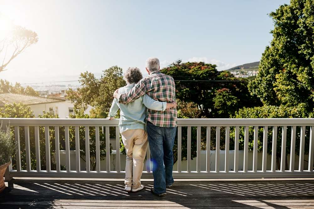 retirees looking over a balcony