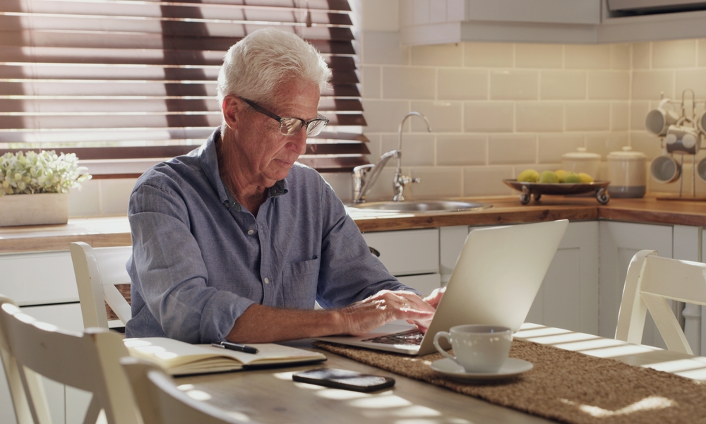 old man using laptop